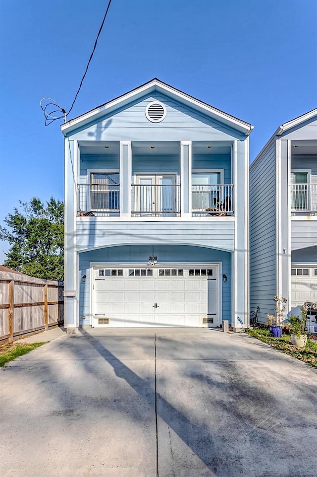 3108 Rogers St, Houston, TX 77022 - view of front of property featuring a balcony, an attached garage, fence, and driveway