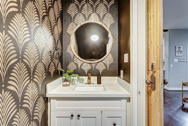 3108 Rogers St, Houston, TX 77022 - bathroom featuring wallpapered walls, vanity, wood finished floors, and baseboards