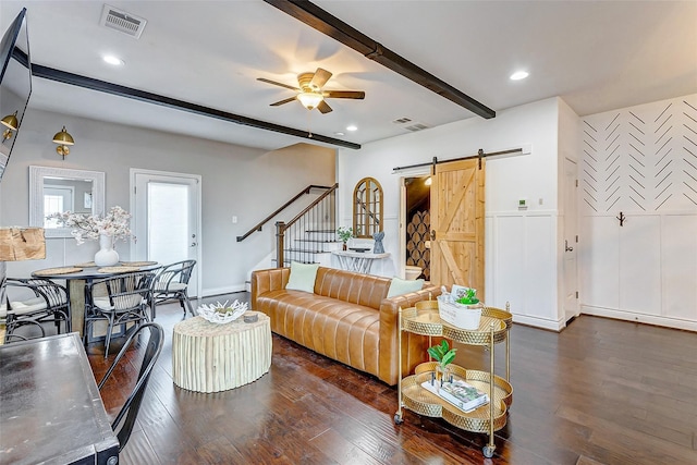 3108 Rogers St, Houston, TX 77022 - living area featuring a barn door, beamed ceiling, a ceiling fan, dark wood-style floors, and stairway