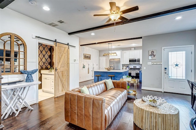 3108 Rogers St, Houston, TX 77022 - living room featuring a barn door, beamed ceiling, dark wood finished floors, a ceiling fan, and recessed lighting