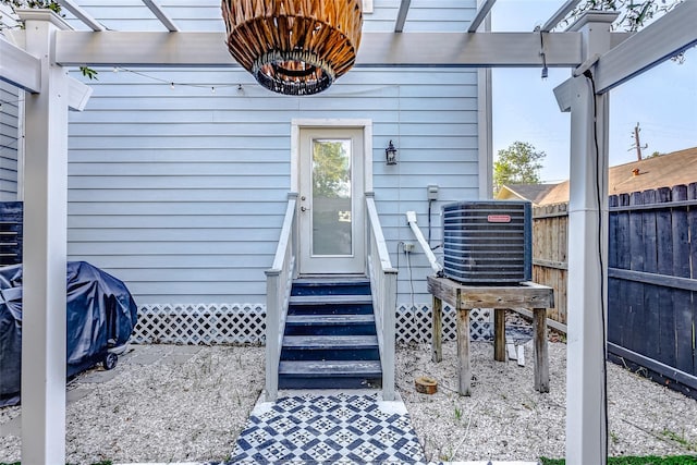 3108 Rogers St, Houston, TX 77022 - view of exterior entry featuring central AC, fence, and a pergola