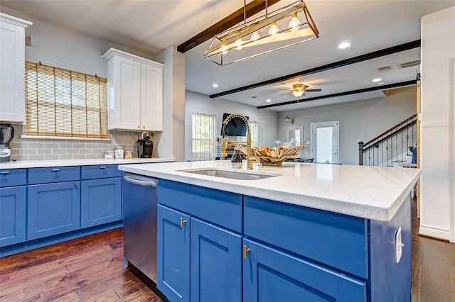 3108 Rogers St, Houston, TX 77022 - kitchen with blue cabinets, dishwasher, white cabinets, dark wood finished floors, and decorative backsplash