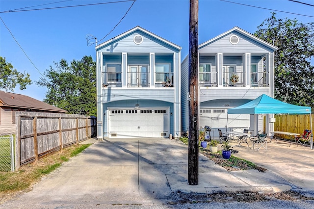 3108 Rogers St, Houston, TX 77022 - view of front of house featuring an attached garage, fence, driveway, and a balcony