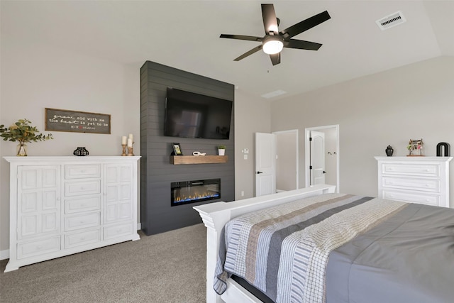 10718 Winding Green Dr, Humble, TX 77338 - carpeted bedroom with a large fireplace, lofted ceiling, and a ceiling fan