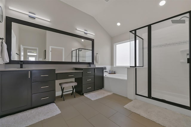 10718 Winding Green Dr, Humble, TX 77338 - bathroom with a stall shower, vaulted ceiling, double vanity, a bath, and recessed lighting