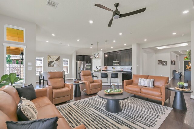 10718 Winding Green Dr, Humble, TX 77338 - living room featuring wood finished floors, a ceiling fan, recessed lighting, and baseboards