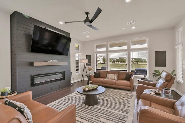 10718 Winding Green Dr, Humble, TX 77338 - living room with a large fireplace, ceiling fan, wood finished floors, baseboards, and recessed lighting