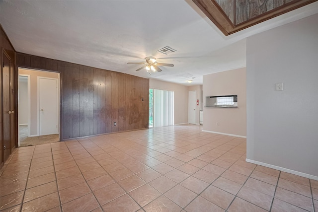 3619 Kilkenny Dr, Houston, TX 77047 - unfurnished room with wood walls, a ceiling fan, light tile patterned flooring, and baseboards