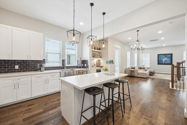 1226 W 17th St Unit E, Houston, TX 77008 - kitchen featuring a sink, a kitchen bar, backsplash, healthy amount of natural light, and recessed lighting