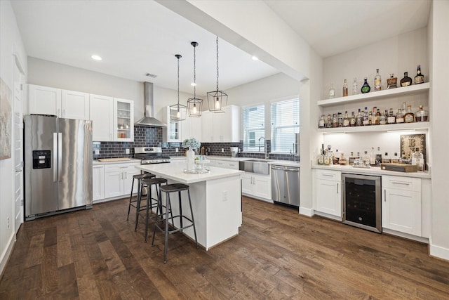 1226 W 17th St Unit E, Houston, TX 77008 - kitchen with appliances with stainless steel finishes, wine cooler, wall chimney range hood, a sink, and tasteful backsplash