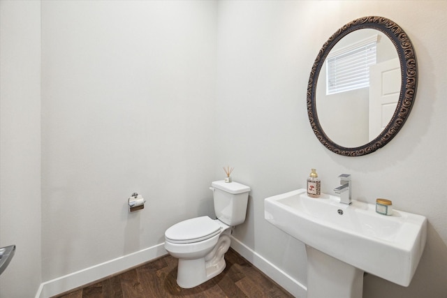 1226 W 17th St Unit E, Houston, TX 77008 - bathroom featuring baseboards, toilet, wood finished floors, and a sink