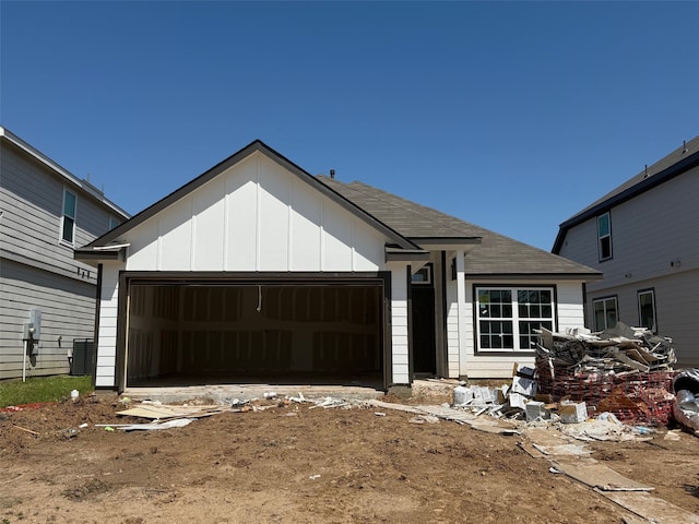 5615 Briana Dee Dr, Rosharon, TX 77583 - view of front of house featuring an attached garage, board and batten siding, and a shingled roof