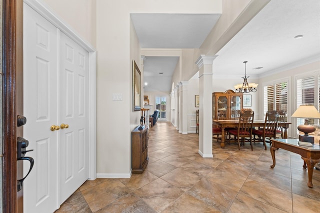 5418 Brook Bend Dr, Sugar Land, TX 77479 - foyer with plenty of natural light, ornate columns, a chandelier, baseboards, and ornamental molding