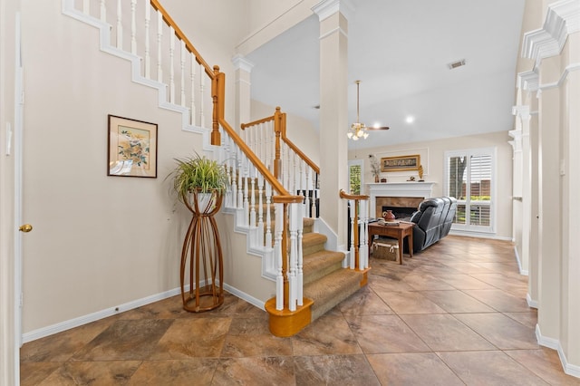 5418 Brook Bend Dr, Sugar Land, TX 77479 - stairs featuring a tile fireplace, baseboards, and a chandelier