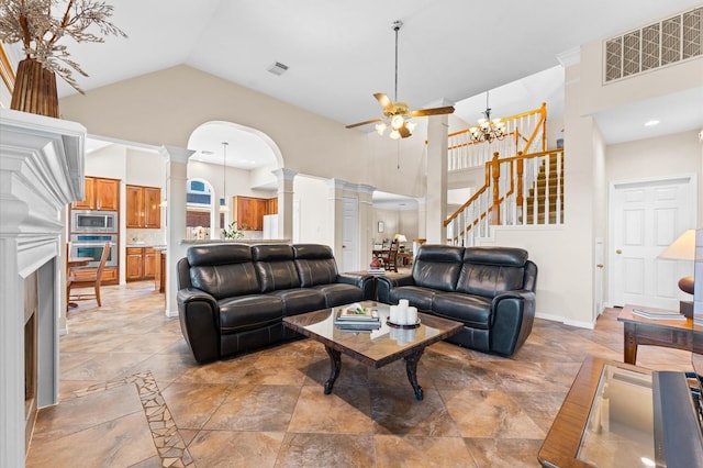 5418 Brook Bend Dr, Sugar Land, TX 77479 - living room with decorative columns, high vaulted ceiling, a ceiling fan, stairs, and a chandelier