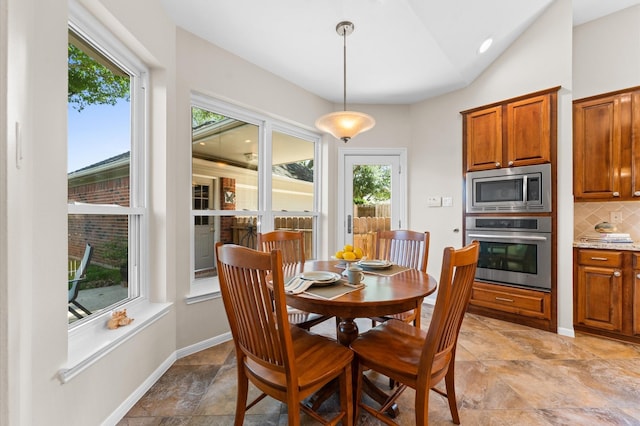 5418 Brook Bend Dr, Sugar Land, TX 77479 - dining area with plenty of natural light, vaulted ceiling, and baseboards