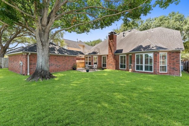 5418 Brook Bend Dr, Sugar Land, TX 77479 - rear view of house with brick siding, a chimney, and a patio area