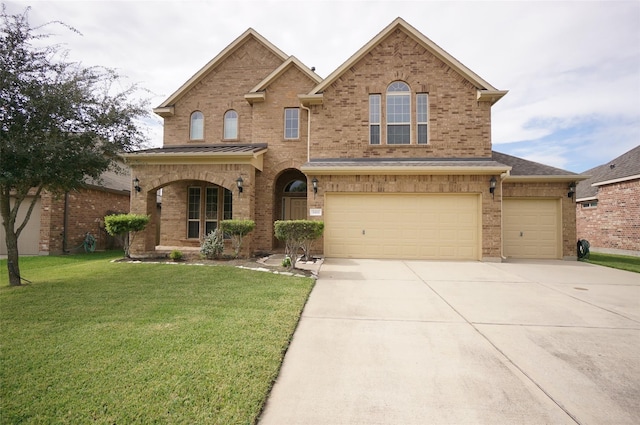 3411 Hawkins Glen Ln, Katy, TX 77449 - view of front facade featuring brick siding, concrete driveway, a front yard, and an attached garage
