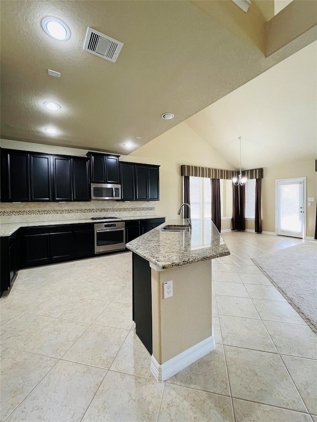 3411 Hawkins Glen Ln, Katy, TX 77449 - kitchen featuring stainless steel appliances, dark cabinets, a sink, healthy amount of natural light, and recessed lighting