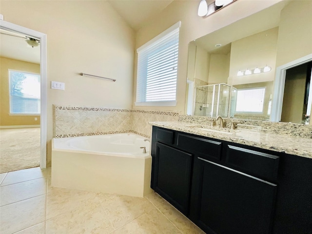 3411 Hawkins Glen Ln, Katy, TX 77449 - full bath featuring a shower stall, plenty of natural light, tile patterned flooring, vanity, and vaulted ceiling