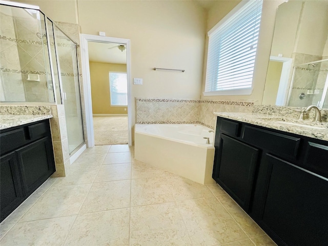 3411 Hawkins Glen Ln, Katy, TX 77449 - full bathroom featuring a shower stall, two vanities, tile patterned floors, a garden tub, and a ceiling fan