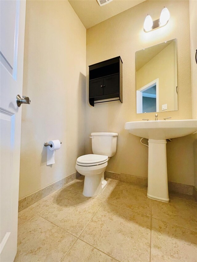 3411 Hawkins Glen Ln, Katy, TX 77449 - bathroom featuring toilet, tile patterned floors, and baseboards