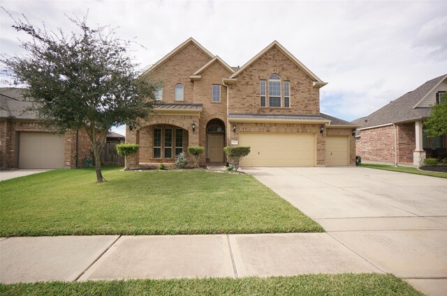 3411 Hawkins Glen Ln, Katy, TX 77449 - traditional home with brick siding, concrete driveway, a front yard, and an attached garage