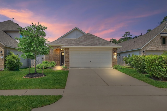 view of front of property with brick siding, concrete driveway, a garage, and a shingled roof
