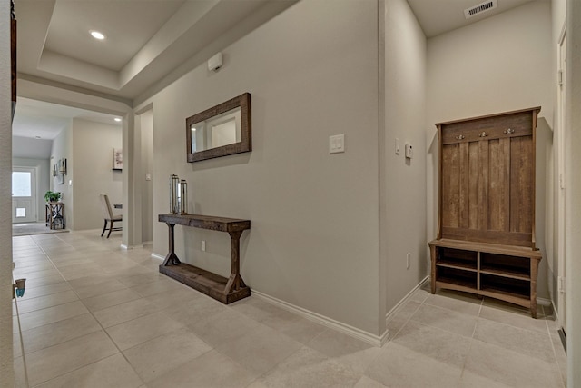 hallway with light tile patterned floors, baseboards, and recessed lighting