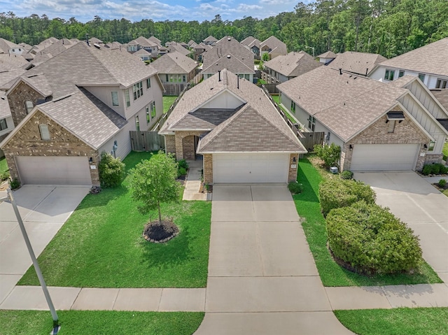 view of front of house featuring brick siding, a residential view, a garage, and concrete driveway
