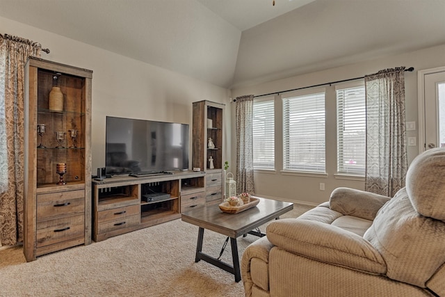 living room with carpet floors, lofted ceiling, and baseboards