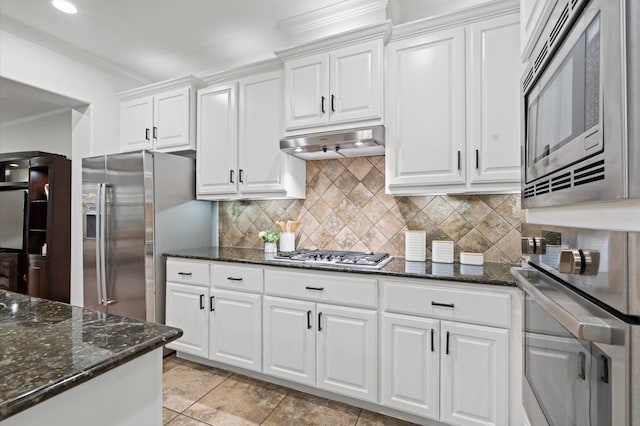 1117 Beall Landing Ct, Houston, TX 77008 - kitchen with appliances with stainless steel finishes, crown molding, under cabinet range hood, white cabinets, and backsplash