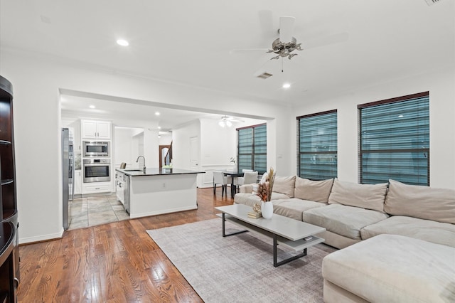 1117 Beall Landing Ct, Houston, TX 77008 - living room with a ceiling fan, light wood-style flooring, and recessed lighting