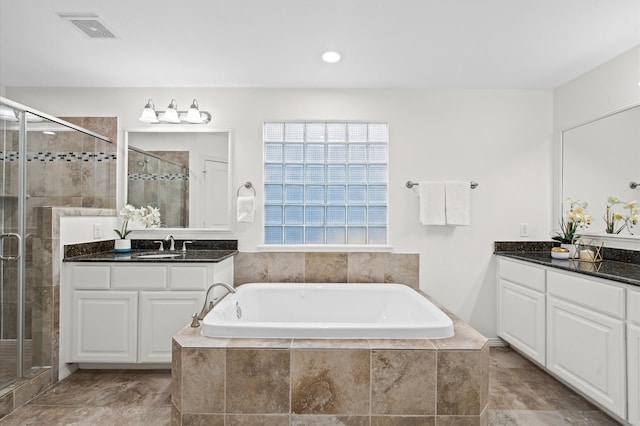 1117 Beall Landing Ct, Houston, TX 77008 - full bathroom featuring a stall shower, a garden tub, and two vanities