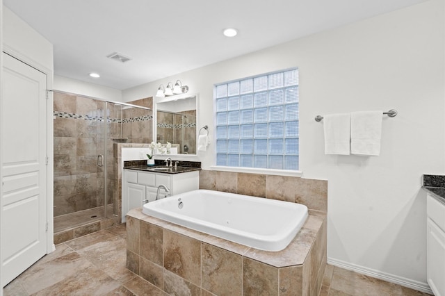 1117 Beall Landing Ct, Houston, TX 77008 - bathroom featuring vanity, a shower stall, a garden tub, and recessed lighting