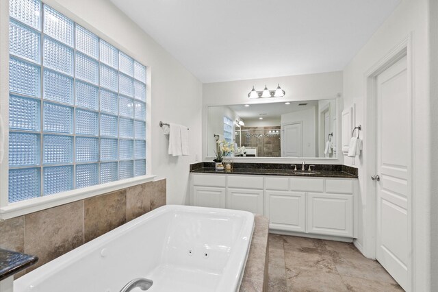 1117 Beall Landing Ct, Houston, TX 77008 - bathroom featuring plenty of natural light, a stall shower, a tub with jets, and vanity