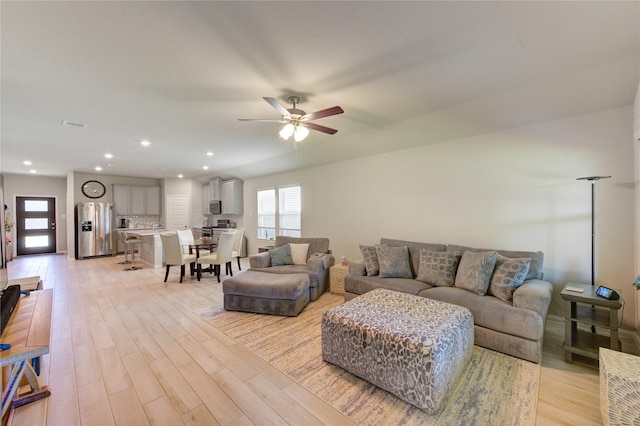 12917 S Winding Pines Dr, Tomball, TX 77375 - living room featuring plenty of natural light, light wood finished floors, a ceiling fan, and recessed lighting