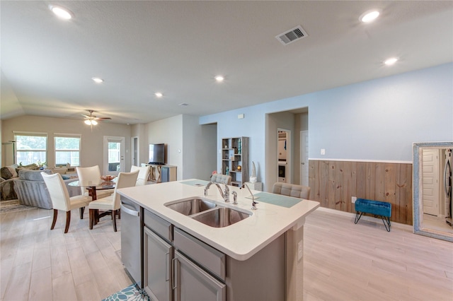 12917 S Winding Pines Dr, Tomball, TX 77375 - kitchen with open floor plan, a sink, gray cabinets, light wood-type flooring, and wainscoting