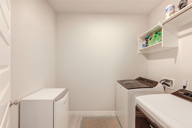 12917 S Winding Pines Dr, Tomball, TX 77375 - clothes washing area with washer and clothes dryer and baseboards