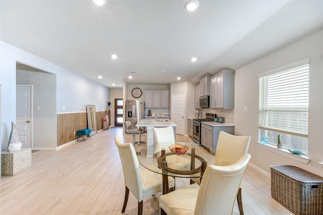 12917 S Winding Pines Dr, Tomball, TX 77375 - dining room with light wood-style flooring, baseboards, a wainscoted wall, and recessed lighting