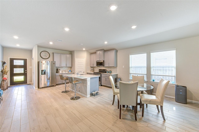 12917 S Winding Pines Dr, Tomball, TX 77375 - dining space with light wood-style flooring, baseboards, and recessed lighting