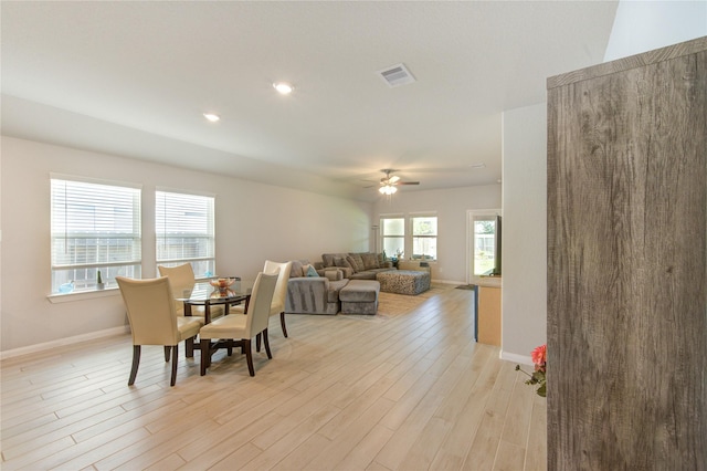 12917 S Winding Pines Dr, Tomball, TX 77375 - dining area with a ceiling fan, light wood finished floors, and baseboards