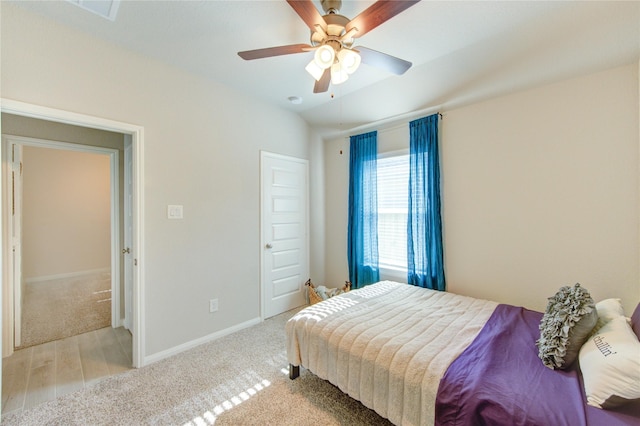 12917 S Winding Pines Dr, Tomball, TX 77375 - carpeted bedroom with baseboards, a ceiling fan, and wood finished floors