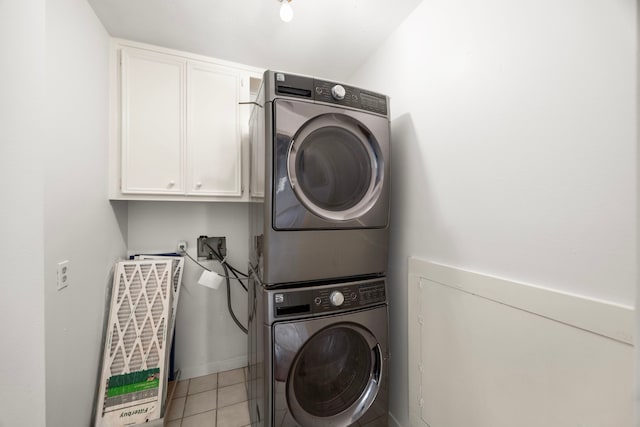 4402 Chipping Ct, Sugar Land, TX 77479 - washroom featuring cabinet space, stacked washer and clothes dryer, and light tile patterned flooring