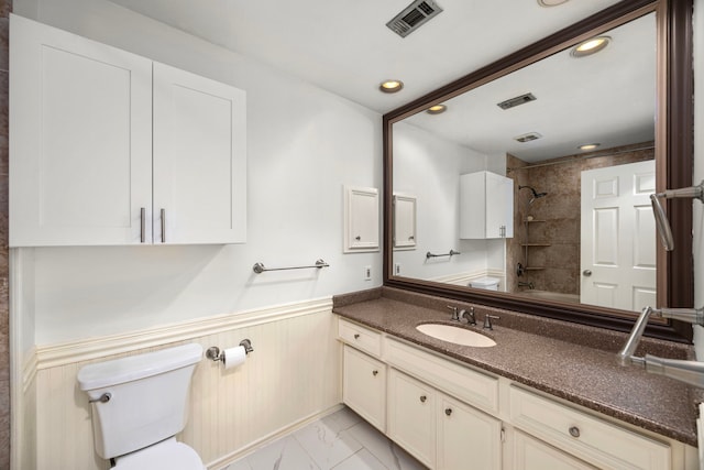 4402 Chipping Ct, Sugar Land, TX 77479 - bathroom featuring marble look tiles, toilet, shower / washtub combination, a wainscoted wall, and vanity