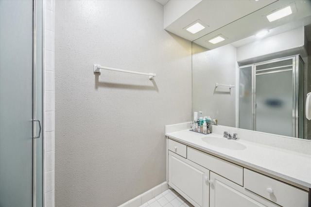 5905 Sugar Hill Dr Unit 221, Houston, TX 77057 - bathroom with a shower stall, vanity, baseboards, and tile patterned flooring