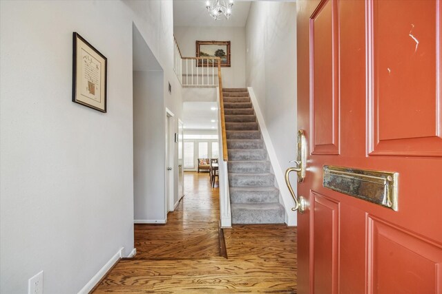 5905 Sugar Hill Dr Unit 221, Houston, TX 77057 - entrance foyer featuring stairway, light wood-style flooring, baseboards, and a chandelier