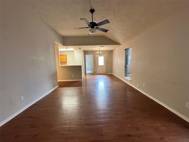 6723 Highwind Bend Ln, Katy, TX 77449 - unfurnished living room featuring lofted ceiling, ceiling fan, a chandelier, dark wood finished floors, and a textured ceiling
