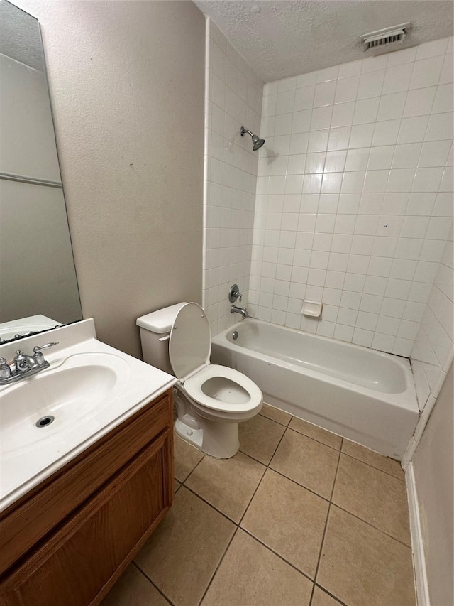 6723 Highwind Bend Ln, Katy, TX 77449 - full bathroom with a textured ceiling, tile patterned floors, toilet,  shower combination, and vanity