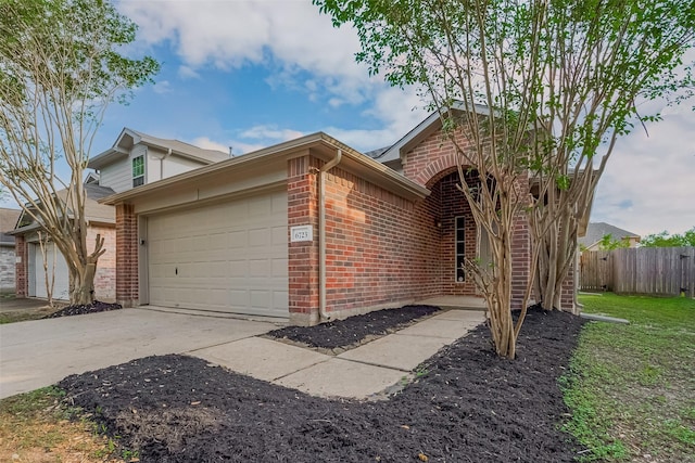 6723 Highwind Bend Ln, Katy, TX 77449 - view of front of property with brick siding, an attached garage, and concrete driveway